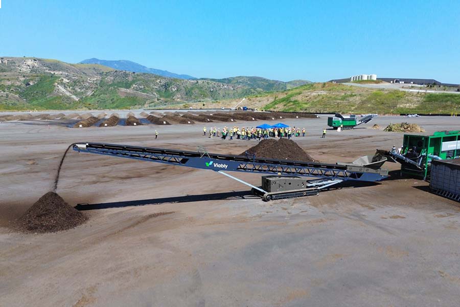 Wide shot of a Viably mobile conveyor being fed by a Komptech Multistar star screen.