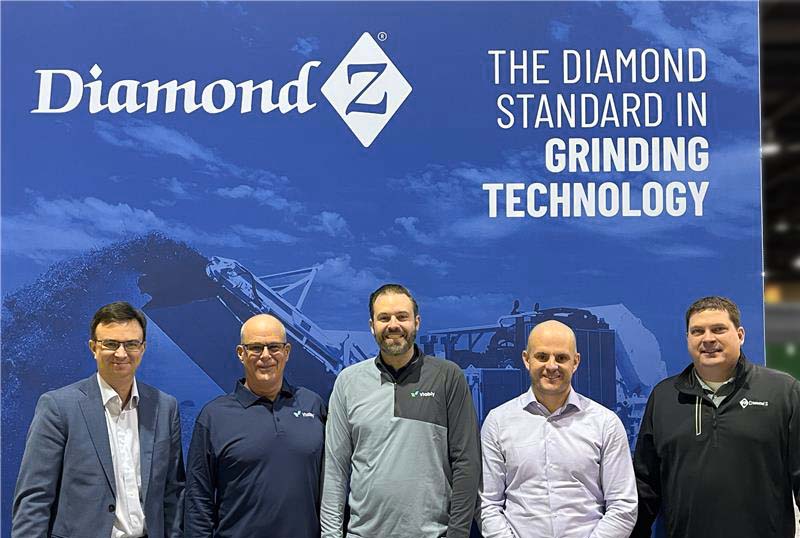 Viably and Diamond Z leadership teams stand together in a tradeshow booth announcing the new business partnership.