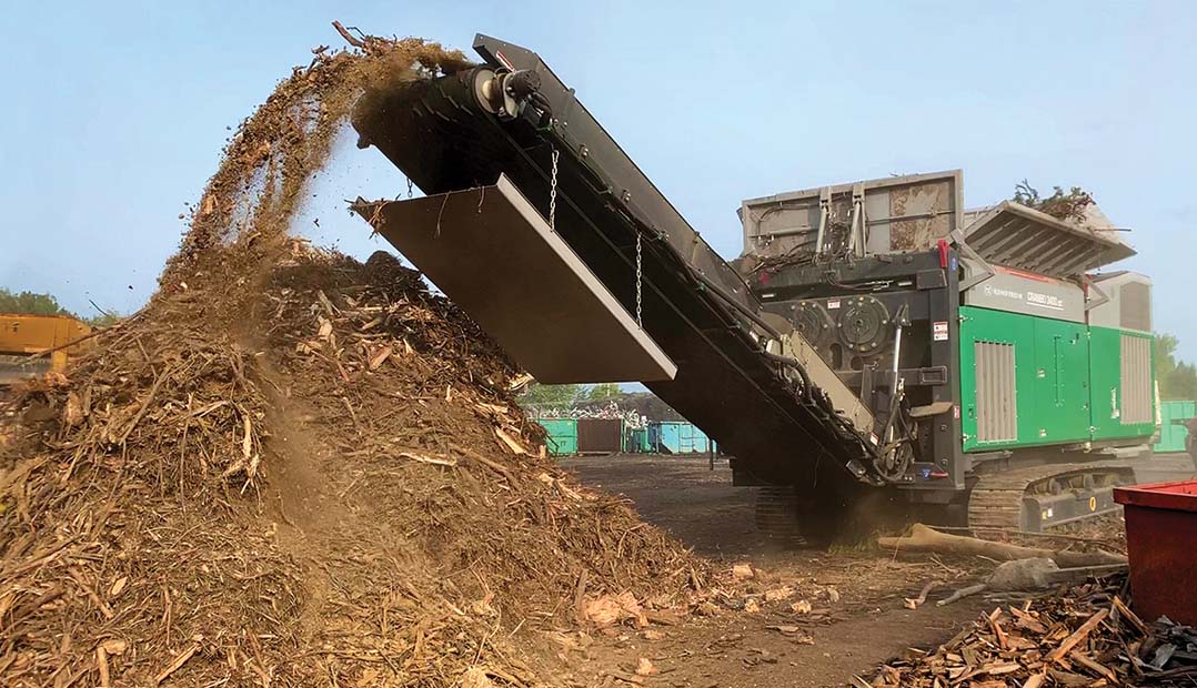 The Komptech Crambo 3400 dual-shaft shredder processing green waste.